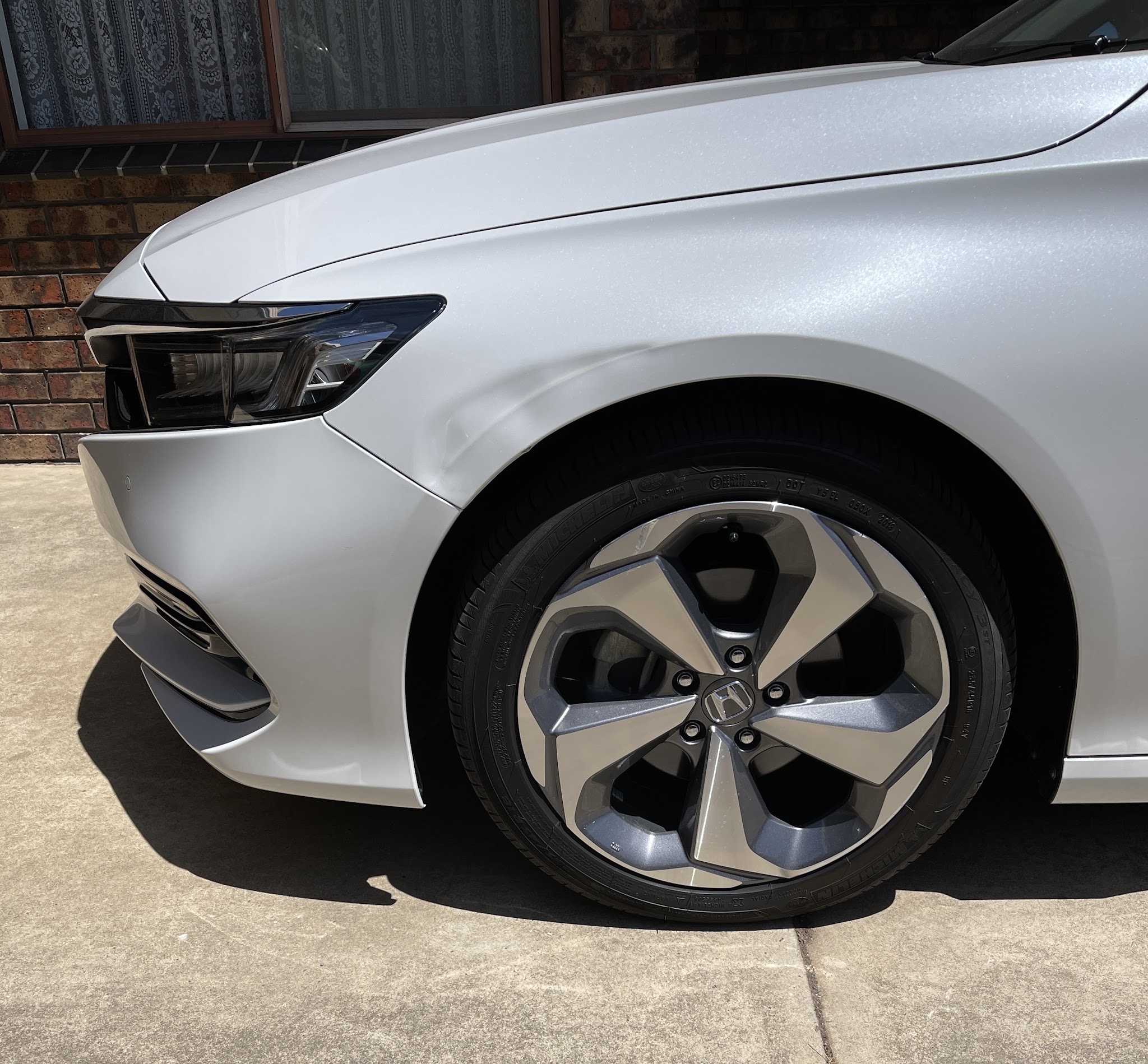 Silver Honda front guard photographed after repair